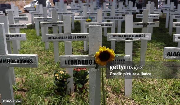 January 2023, Brazil, Brumadinho: Names of the victims of the Brumadinho dam break symbolically on crosses at a meadow. The dam at the Corrego do...