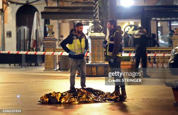 Graphic content / The body of a dead man lays on the ground as police secure the area in Algeciras, southern Spain, on January 25, 2023. - Spain...