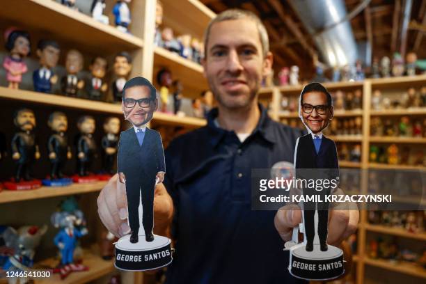 Phil Sklar, Co-Founder and CEO of the National Bobblehead Hall of Fame and Museum, holds newly designed bobblehead cutouts of recently elected...