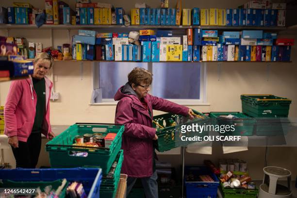 Workers at the Coventry Foodbank centre in Queens Road Baptist Church collate donated food items into parcels that will be provided to people...