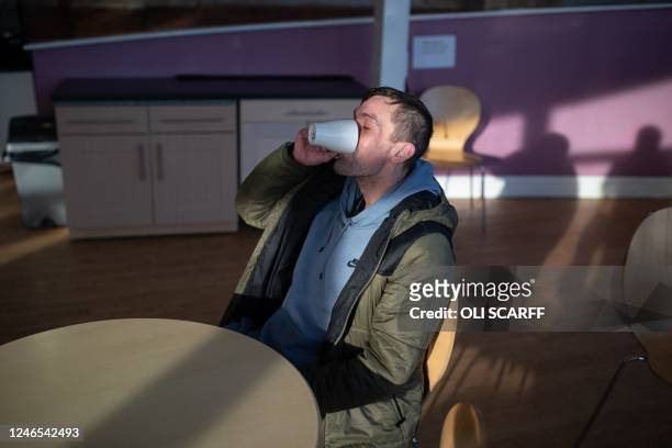 Customer of the Coventry Foodbank centre in Queens Road Baptist Church enjoys a hot drink after collecting his food parcel, in Coventry, central...