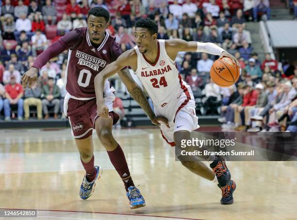 Brandon Miller of the Alabama Crimson Tide drives to the basket during the first half against D.J. Jeffries of the Mississippi State Bulldogs at...