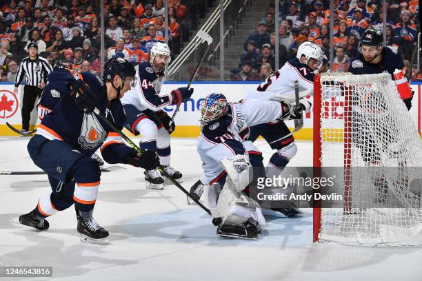 Joonas Korpisalo of the Columbus Blue Jackets makes a save against Dylan Holloway of the Edmonton Oilers during the game on January 25, 2023 at...