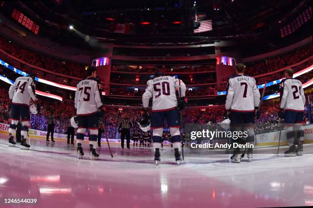 The starting lineup of the Columbus Blue Jackets stands for the playing of the national anthem before the game against the Edmonton Oilers on January...