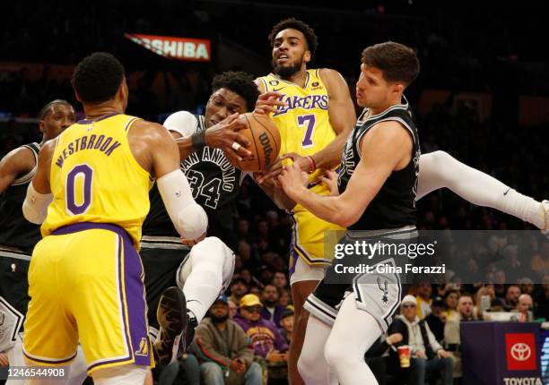 San Antonio Spurs forward Stanley Johnson grabs a defensive rebound in front of Los Angeles Lakers forward Troy Brown Jr. And Los Angeles Lakers...