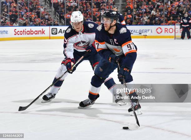 Connor McDavid of the Edmonton Oilers skates against Patrik Laine of the Columbus Blue Jackets during the game on January 25, 2023 at Rogers Place in...