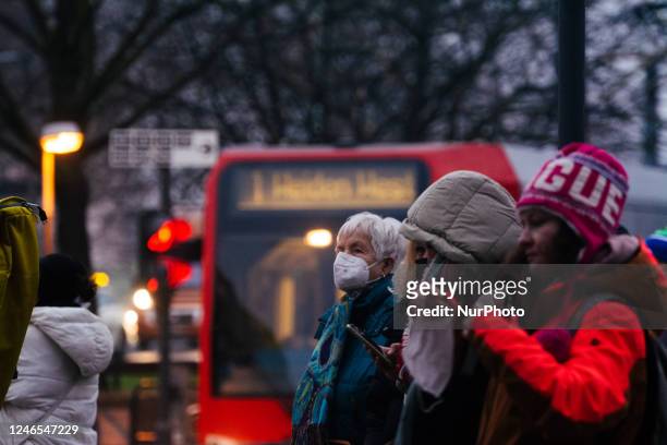 Passengers are seen waiting for the street bahn in Cologne, Germany on January 25 as the state government of NRW is dropping the mask mandate in...