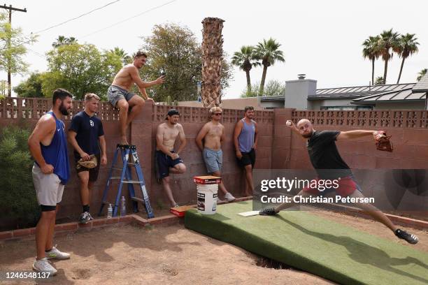 Pitcher Joe Kuzia with the Texas Rangers throws a pitch in front of Jakob Junis with the Kansas City Royals, Nick Kuzia with the San Diego Padres,...