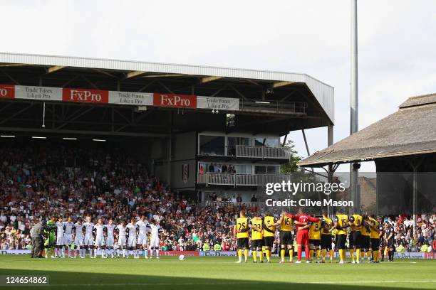 The teams line up to observe a minutes silence on the tenth anniversary of the terror attacks in the USA during the Barclays Premier League match...