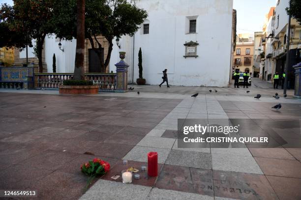 Picture taken on January 26, 2023 in Algeciras, southern Spain shows flowers and candles displayed on the square near the church where a man was...
