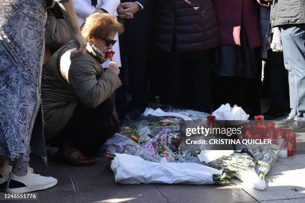 Relatives and friends of the victim react during a minute of silence near the church where a sacristan was killed the day before on Alta square in...