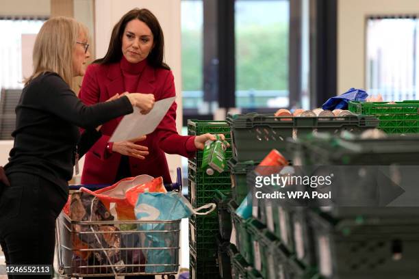 Britain's Catherine, Princess of Wales helps collect food during a visit to the Windsor Foodshare on January 26, 2023 in WIndsor, England. The Prince...
