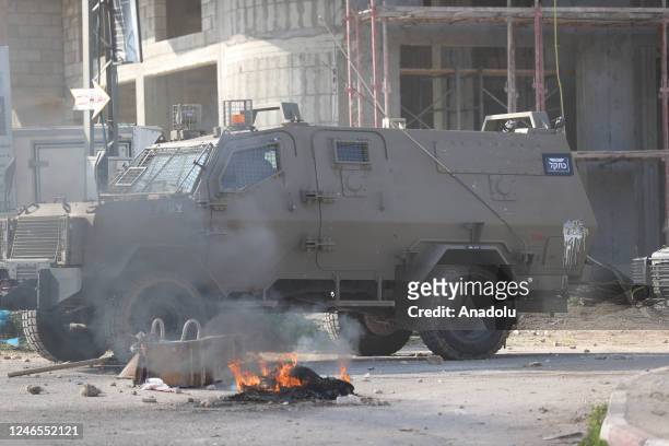 View of a military vehicle as Palestinians clash with Israeli soldiers after Israeli forces raided the refugee camp and killed 9 Palestinians in...