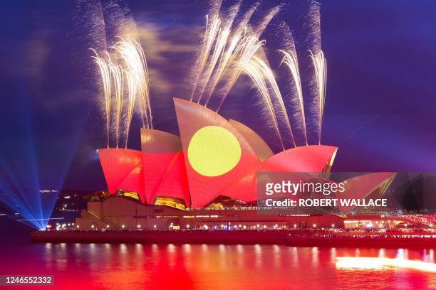 This picture shows the Opera House illuminated in the colours of the Aboriginal flag in Sydney on Australia Day on January 26, 2023.