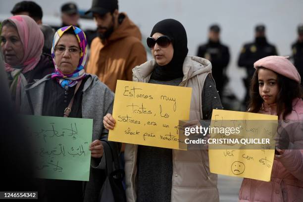 Muslim women hold signs reading 'Islam has nothing to do with it' and 'we are sad, in shock' near the church where a man was killed in Alta square,...