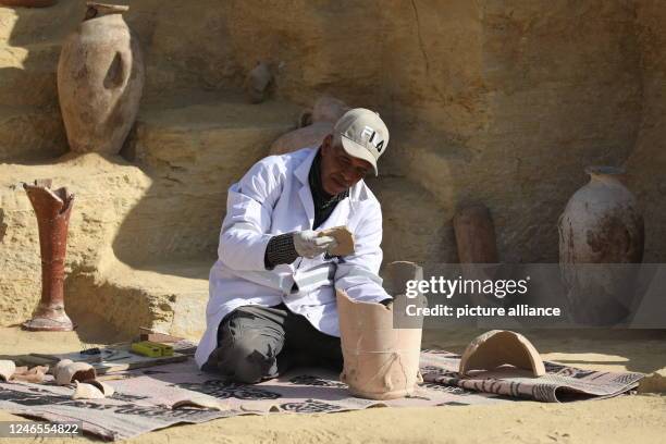 January 2023, Egypt, Giza: An Egyptian archaeologist restores some antiquotes at the site of the Step Pyramid of Djoser. Former Egyptian Minister of...