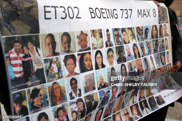 Relatives of victims hold a placard with the victims of Ethiopia flight 302 the US Courthouse before Boeing is to be arraigned on federal crime...