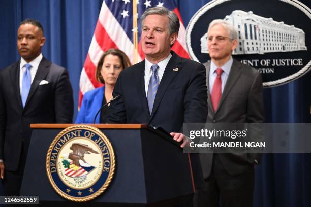 Director Christopher Wray with Deputy Attorney General Lisa Monaco , and US Attorney General Merrick Garland , speaks during a press conference to...