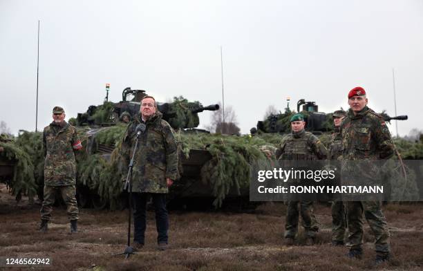 German Defence Minister Boris Pistorius stands next to Arne Collatz , Colonel in the General Staff, and in front of Puma infantry fighting vehicles...