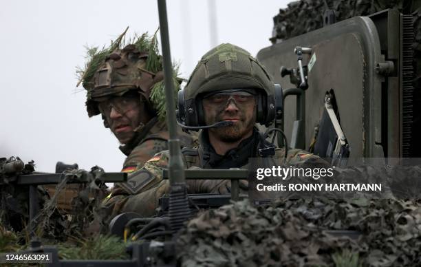 German soldiers are seen on a Puma infantry fighting vehicle of the German armed forces Bundeswehr during an exercise at a military training area in...