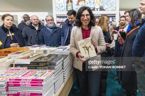 French Culture Minister Rima Abdul-Malak poses with a book by Catel and Bocquet entitled "Josephine Baker" as she visits the "Monde des Bulles"...