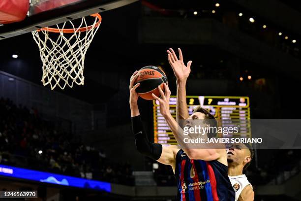 Barcelona's Czech pivot Jan Vesely jumps with the ball and scores during the Euroleague Basketball match between Real Madrid and FC Barcelona at the...