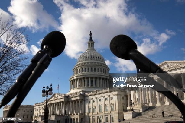 Microphones sit on a podium before the start of a news conference with Democratic lawmakers about the Biden administrations border politics, outside...