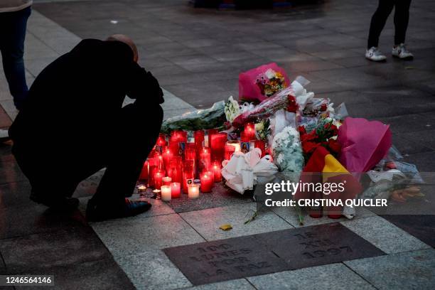 People light candles and lay flowers after an attack in a church in Alta square, in Algeciras, southern Spain, on January 26, 2023. - Spain opened a...