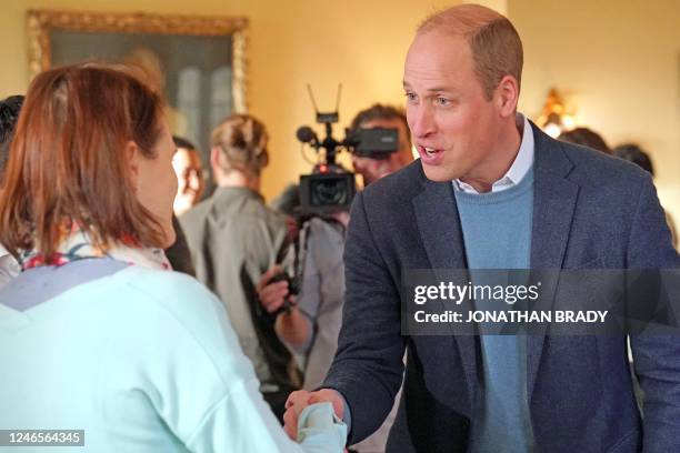 Britain's Prince William, Prince of Wales shakes hands as he speaks to one of the Earthshot Prize 2022 finalists, as he joins them at the Earthshot...