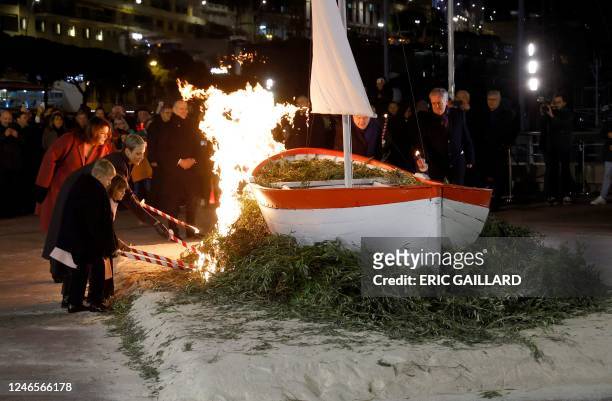 Monaco's Princess Charlene and her children Prince Jacques and Princess Gabriella set alight a sailboat during the traditional festivities of Sainte...