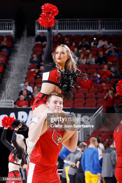 Louisville Cardinals cheerleaders run onto the floor during a college basketball game against the Pittsburgh Panthers on January 18, 2023 at KFC Yum!...