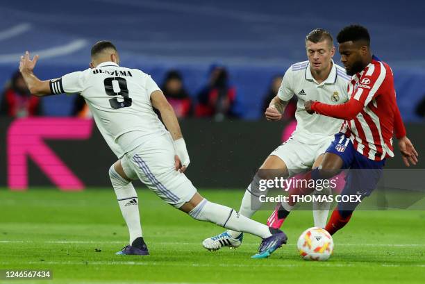 Atletico Madrid's French midfielder Thomas Lemar fights for the ball with Real Madrid's German midfielder Toni Kroos and Real Madrid's French forward...
