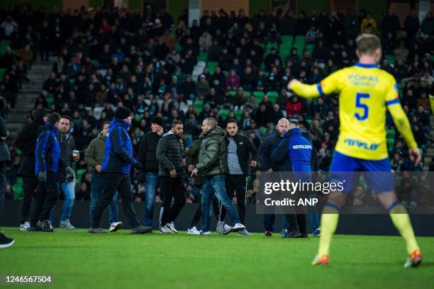 Players supporters of FC Groningen come on the pitch during the Dutch premier league match between FC Groningen and SC Cambuur at Euroborg stadium on...