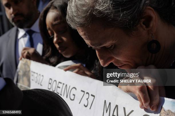Nadia Milleron, who lost her daughter in a Boeing 737 MAX airplane crash, holds a sign amongst other relatives of victims after Boeing was arraigned...