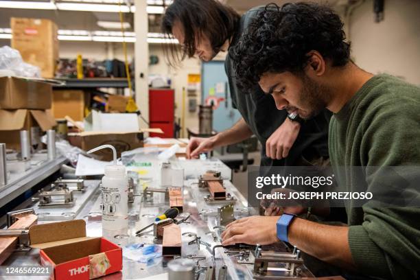 Engineers James Ridzon and Smeet Patel assemble fusion reactor components at the Massachusetts Institute of Technology Plasma Science & Fusion Center...