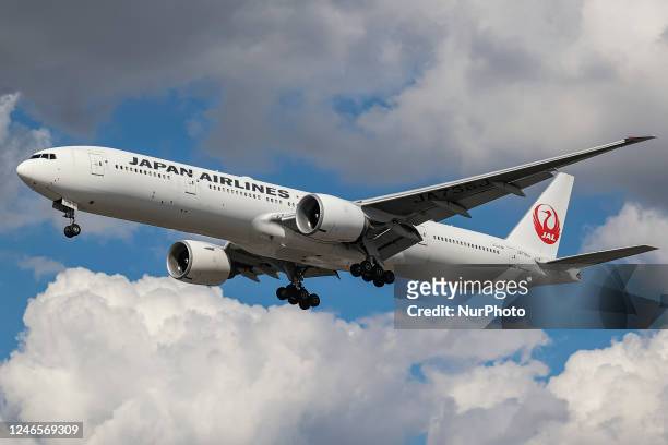 Japan Airlines Boeing 777 aircraft as seen flying on final approach during a blue sky summer sunny day with some clouds, arriving from Tokyo...