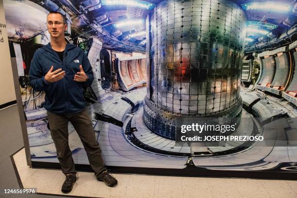 Physicist Stephen Wukitch stands in front of an image view of the former fusion core that is now defunct at the Massachusetts Institute of Technology...
