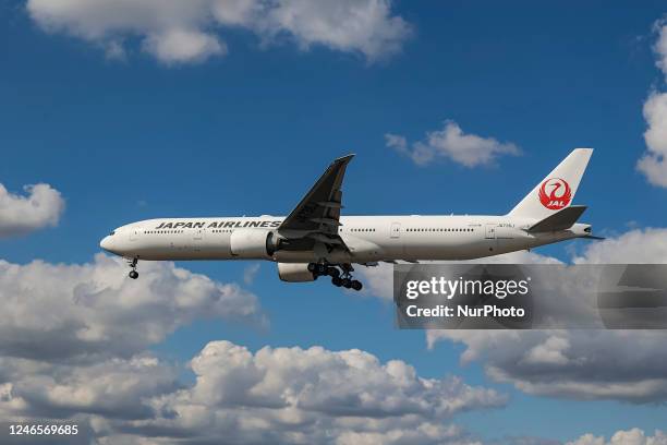 Japan Airlines Boeing 777 aircraft as seen flying on final approach during a blue sky summer sunny day with some clouds, arriving from Tokyo...