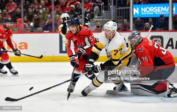 Capitals defenseman Trevor van Riemsdyk clears a rebound from in front of Capitals goalie Darcy Kuemper while Penguins center Jeff Carter goes down...