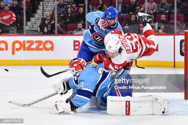Mike Matheson of the Montreal Canadiens takes down Tyler Bertuzzi of the Detroit Red Wings near goaltender Jake Allen during the first period of the...
