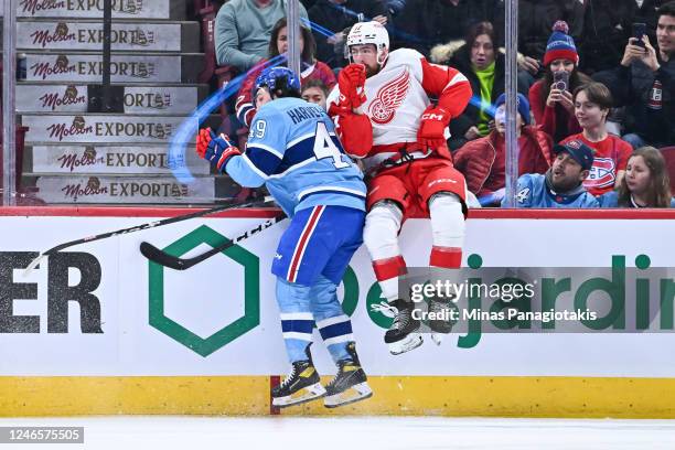 Rafael Harvey-Pinard of the Montreal Canadiens sidesteps a check from Filip Hronek of the Detroit Red Wings during the first period of the game at...