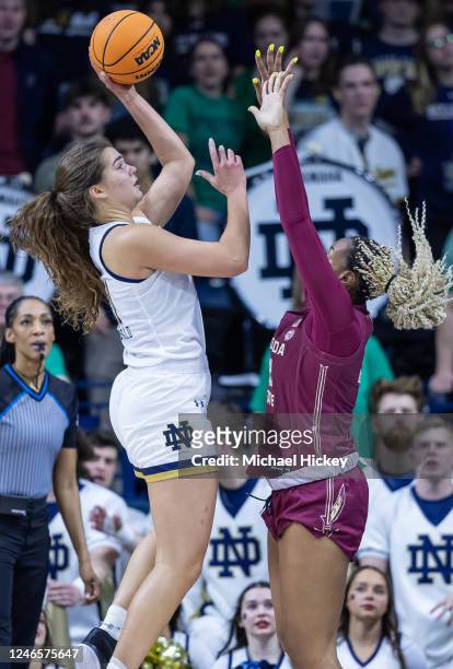 Maddy Westbeld of the Notre Dame Fighting Irish shoots the ball against Valencia Myers of the Florida State Seminoles during the first half of the...