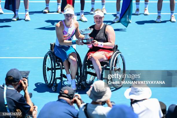 Netherlands' Diede De Groot and Aniek Van Koot pose with the trophy after their victory against Japan's Yui Kamiji and China's Zhu Zhenzhen during...