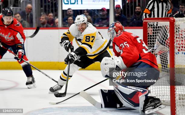 Penguins center Sidney Crosby takes a backhand shot on Capitals goalie Darcy Kuemper during the third period during the Pittsburgh Penguins versus...