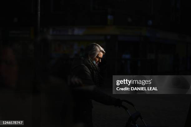 An elderly woman walks through the streets of Grays, Essex, on January 18, 2023. - In the referendum in 2016, 72.3% of voters voted for Brexit in the...