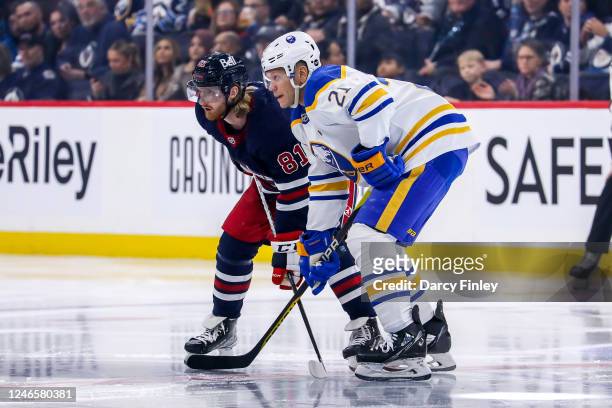 Kyle Connor of the Winnipeg Jets and Kyle Okposo of the Buffalo Sabres get set during a first period face-off at the Canada Life Centre on January...