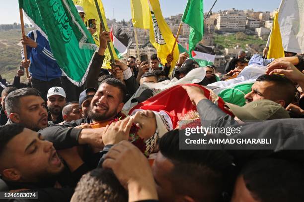 Mourners carry the body of Palestinian youth Yusef Muhaisen, killed by Israeli fire amid clashes, during his funeral in the West Bank town of Al-Ram...