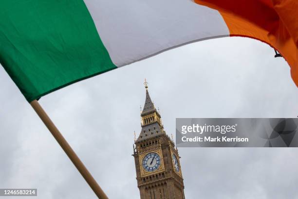 An Irish flag is pictured in front of the Houses of Parliament during a vigil held in Parliament Square to commemorate the 51st anniversary of the...