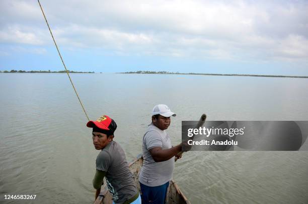 Casper and Yeiner, Wayuu indigenous people, work in the Navio Quebrado lagoon to take tourists to see pink flamingos in Riohacha, La Guajira,...