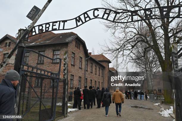 Visitors are seen inside the former Auschwitz I camp in Oswiecim, Poland, on January 27, 2023. The solemn occasion serves as a powerful reminder of...